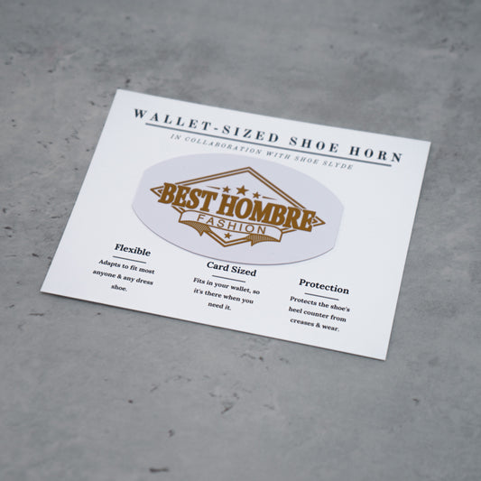 Overhead photo of the gold and white best hombre fashion shoeslyde in packaging